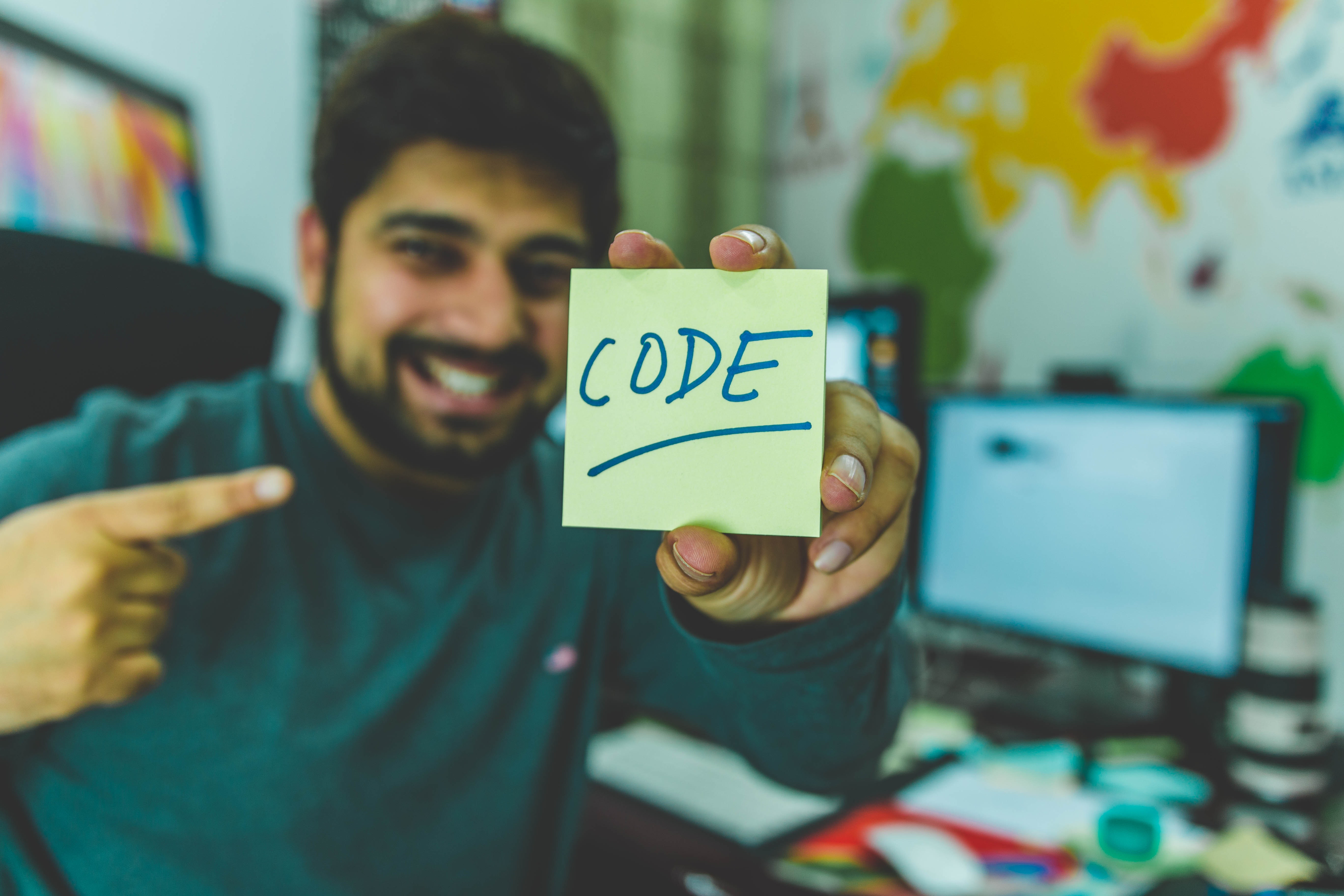 picture of happy man holding up an post-it